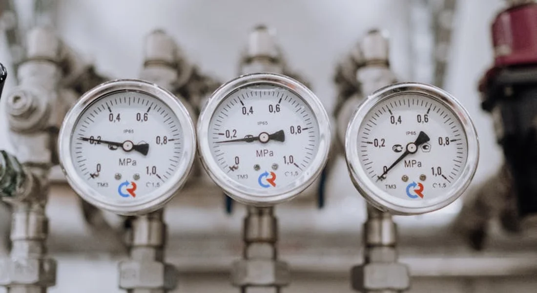 Close-up of three pressure gauges on a plumbing manifold