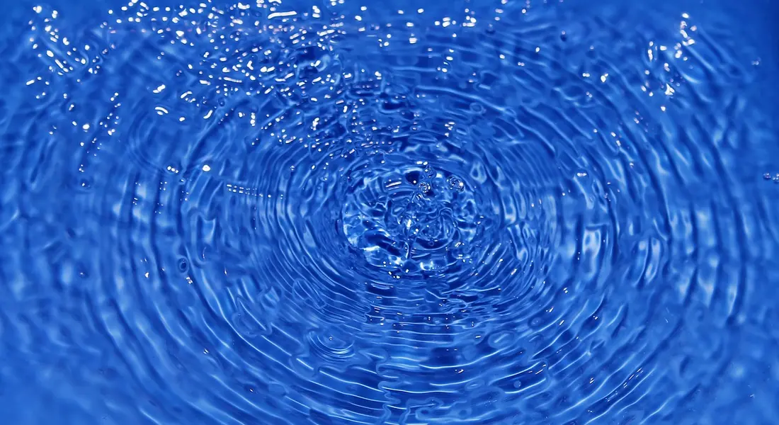 Close-up of blue water with concentric ripples