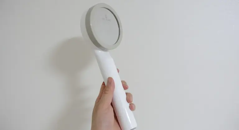 Handheld water testing device being used to check water quality for an aquarium