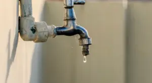 Outdoor wall-mounted faucet with a dripping spout