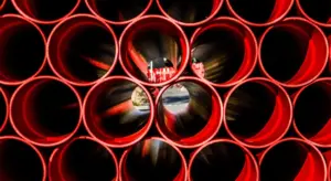 Close-up view of red PEX water pipes with circular openings, ready for installation.