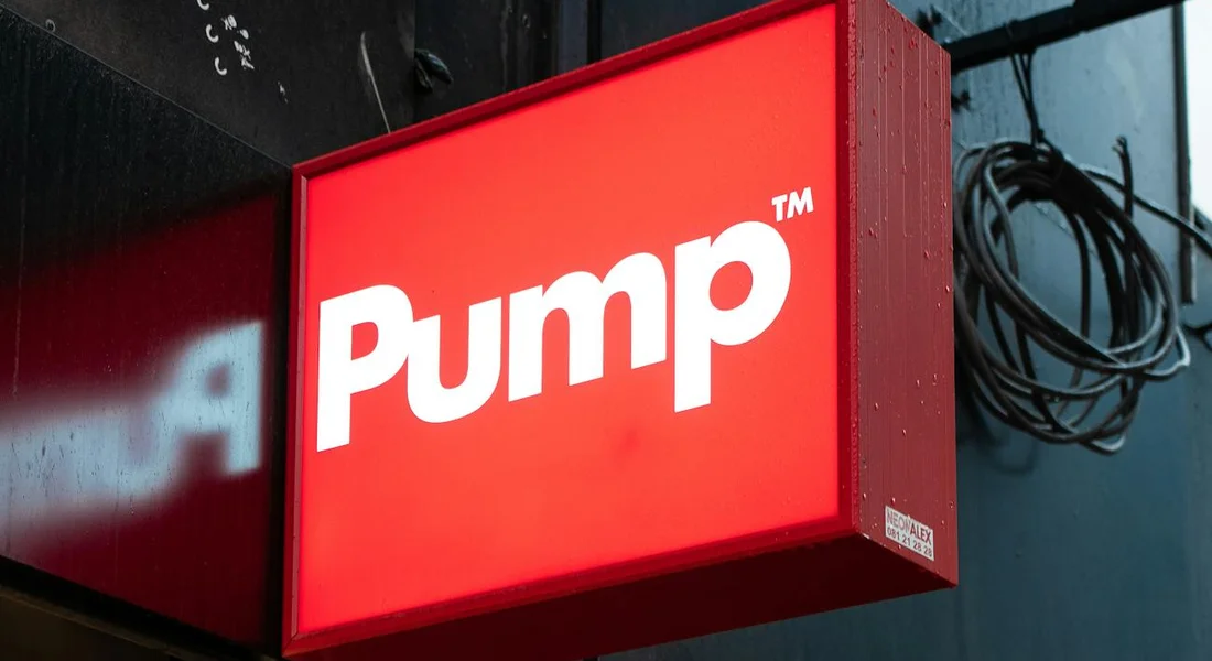 Red sign reading 'Pump' mounted on a building.