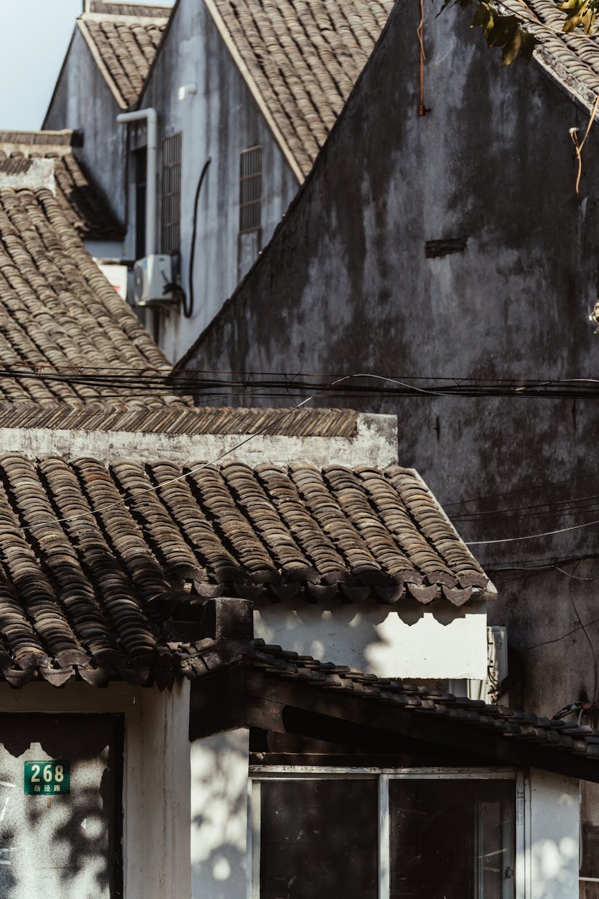 Plumber checking a water heater anode rod and temperature settings.