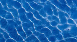 Blue water surface with light reflections, suitable as an image for a water-treatment article.