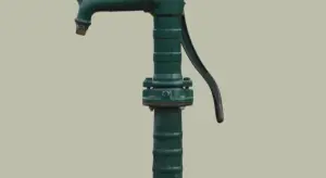 Green sump pump discharge pipe in a basement