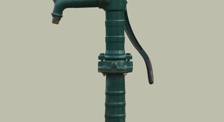 Green sump pump discharge pipe in a basement