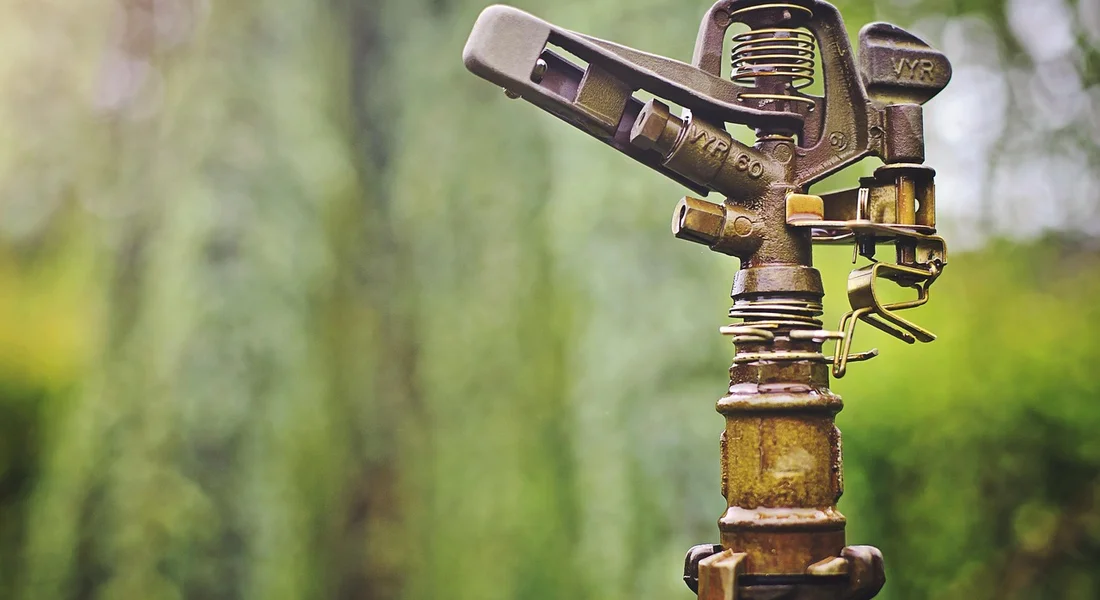 Close-up of a rusty irrigation valve or sprinkler head