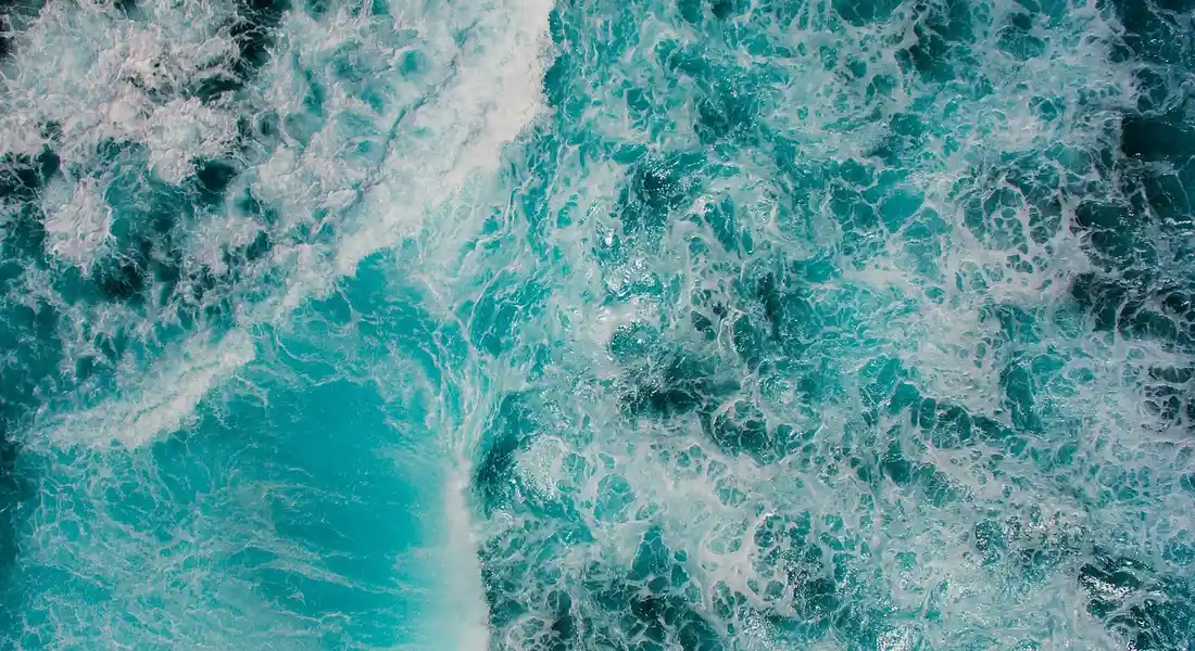 Close-up of turquoise ocean waves with white foam.