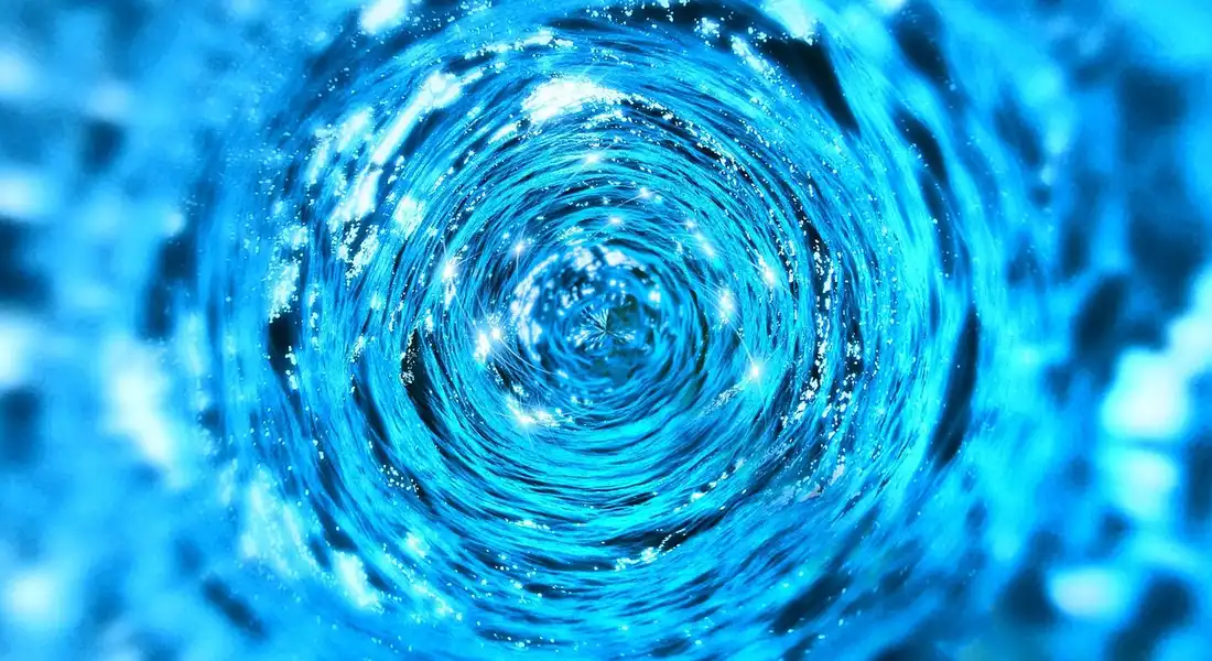 Blue swirling water vortex illustrating careful draining of an old water heater tank