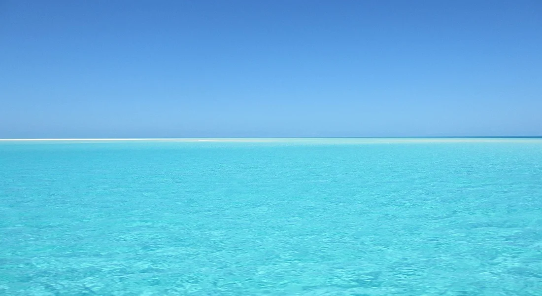 Calm turquoise ocean under a bright blue sky