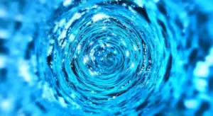 Abstract close-up of a blue swirling water vortex