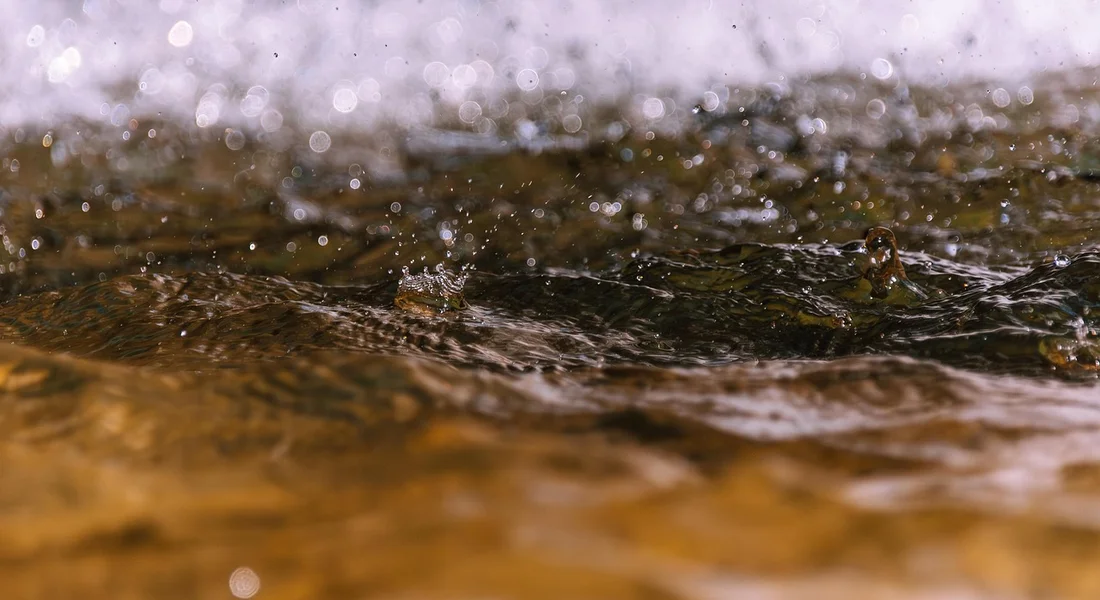 Close-up of moving water with ripples and droplets