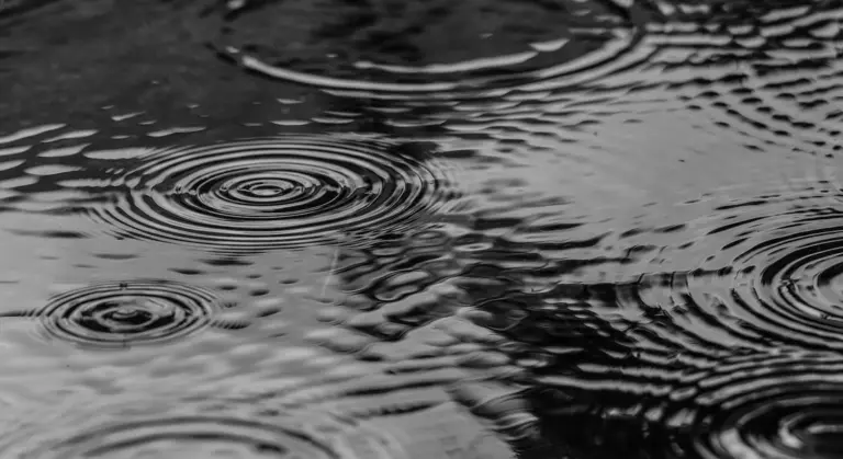 Close-up of a rippling water surface in grayscale