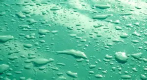 Close-up of water droplets on a turquoise surface
