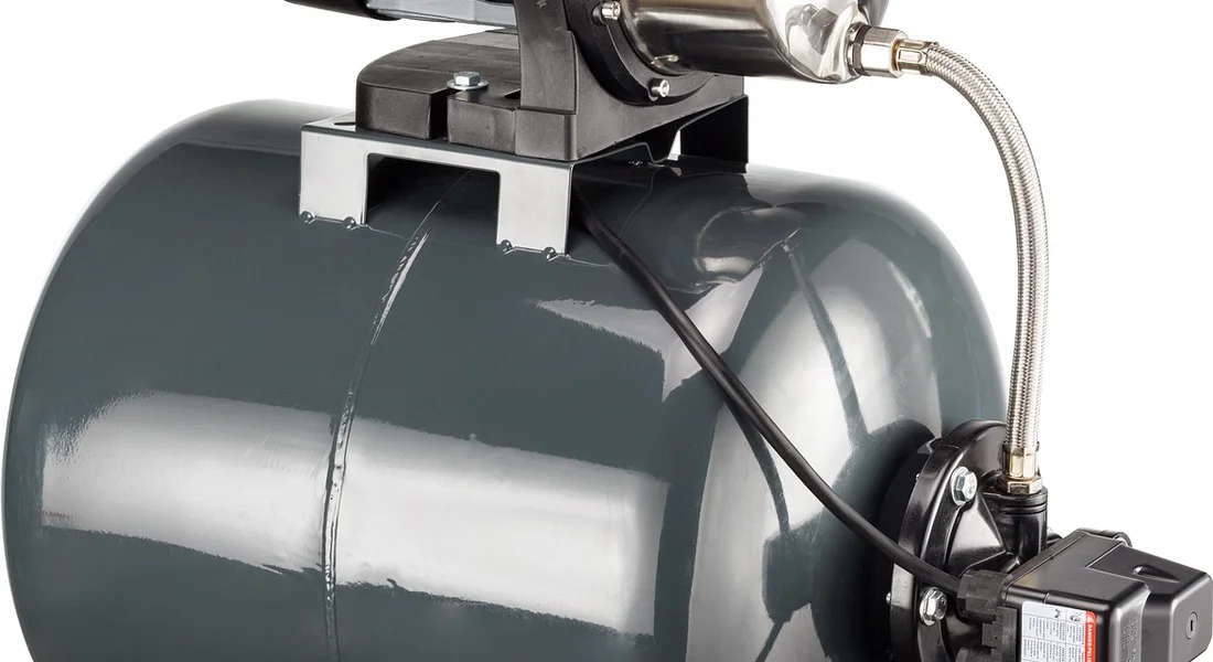 Close-up of a residential well pressure tank with a pressure switch and electrical wiring