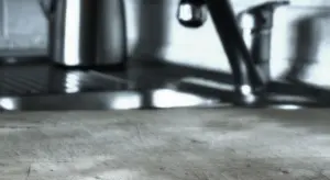 Close-up of a kitchen sink area with a stainless steel faucet and blurred background.