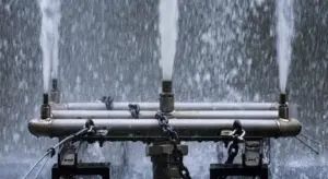 Close-up of a water pressure tank assembly with pipes and valves.